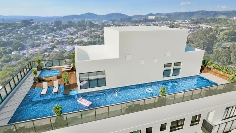 Piscina no rooftop com deck de madeira, espreguicadeiras e vista da cidade